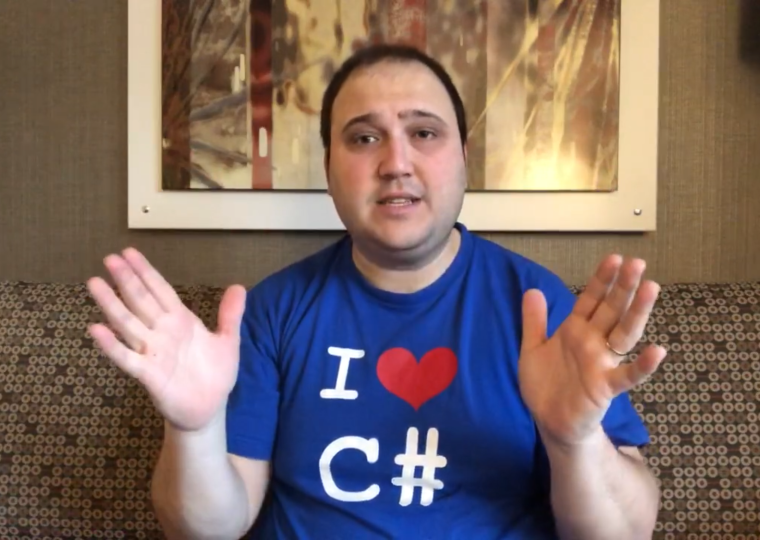 Andrea Angella talking to camera, wearing an I Love C# t-shirt