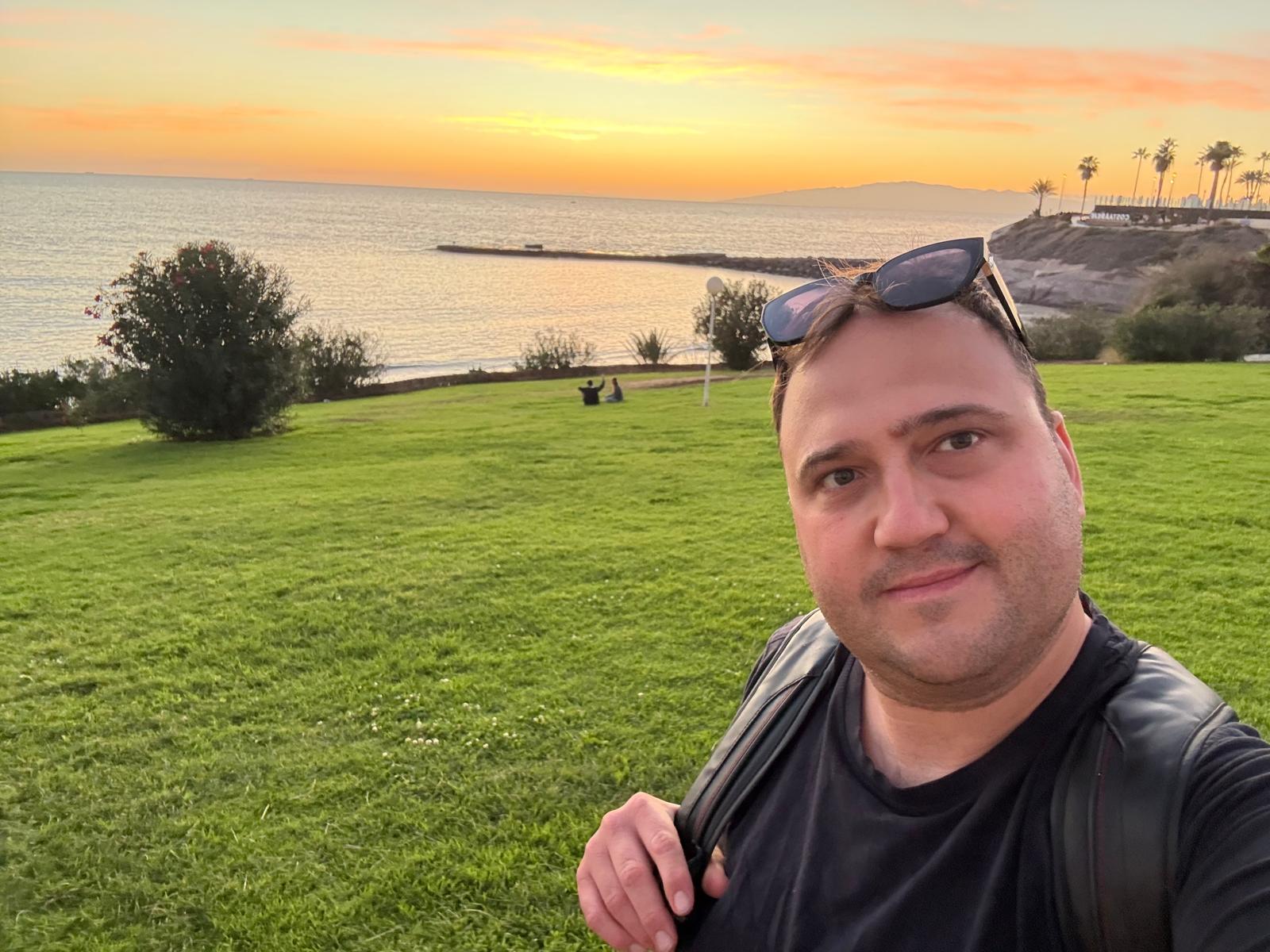 Andrea Angella watching the sunset over the sea